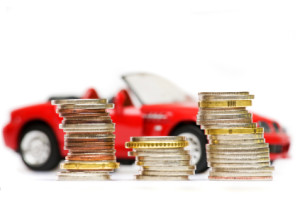 Coin piles over expensive red sport car